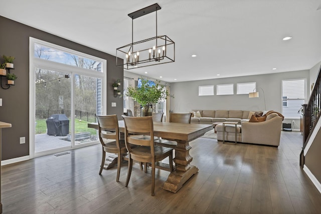 dining area with a chandelier, recessed lighting, a wealth of natural light, and hardwood / wood-style flooring