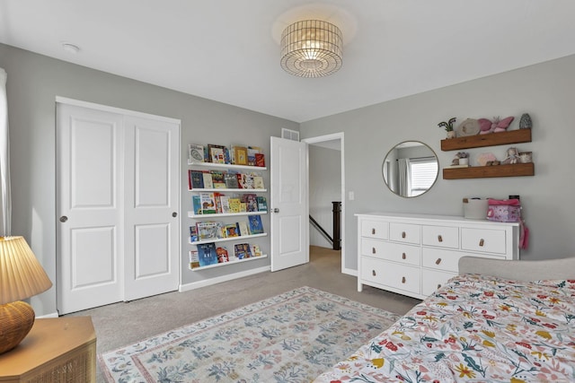 bedroom with a closet, visible vents, and carpet