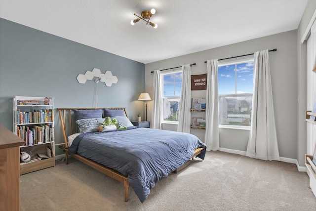 bedroom with carpet flooring and baseboards