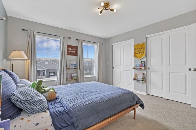 carpeted bedroom featuring two closets