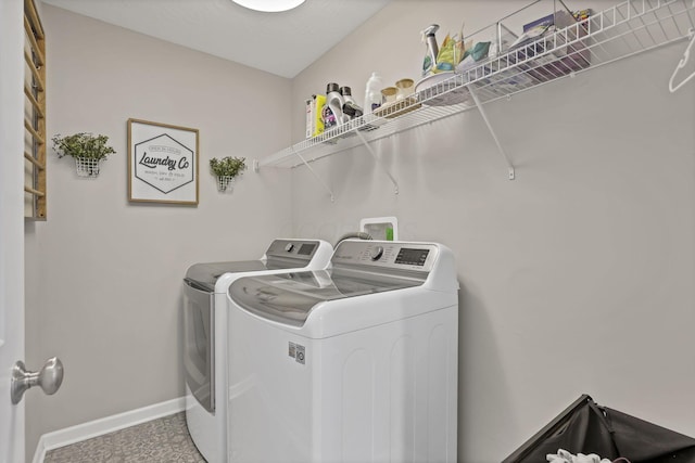 laundry area featuring independent washer and dryer, laundry area, and baseboards