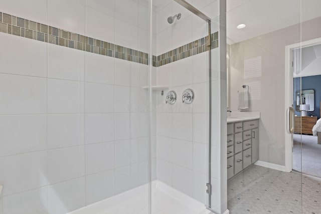 full bath with a shower stall, vanity, and baseboards