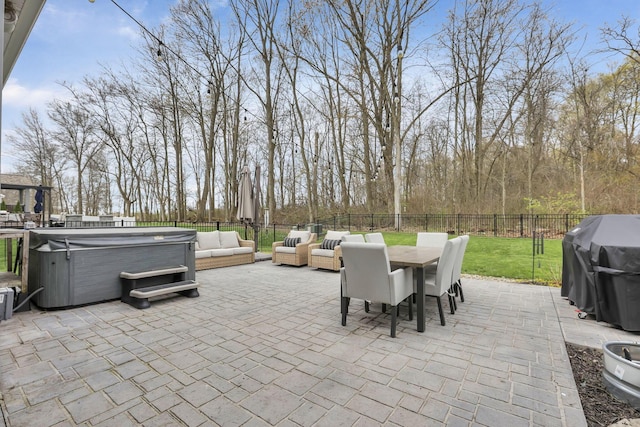 view of patio featuring a hot tub, area for grilling, a fenced backyard, outdoor dining space, and an outdoor hangout area