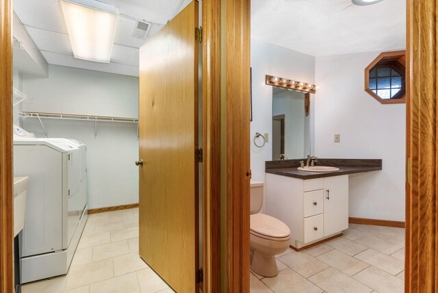 8778 Township Rd 36, Somerset, OH 43783 - bathroom featuring independent washer and dryer, vanity, visible vents, toilet, and tile patterned floors