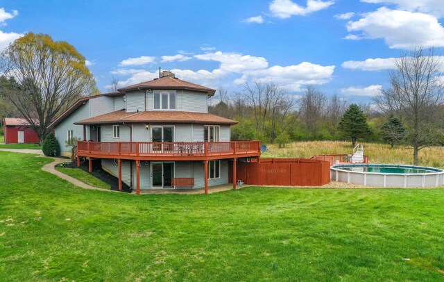 8778 Township Rd 36, Somerset, OH 43783 - back of property featuring a lawn, a chimney, fence, a wooden deck, and a fenced in pool