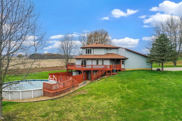8778 Township Rd 36, Somerset, OH 43783 - rear view of property featuring roof with shingles, an outdoor pool, stairs, a wooden deck, and a yard