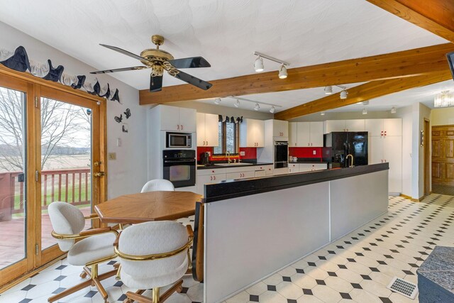 8778 Township Rd 36, Somerset, OH 43783 - kitchen with stainless steel microwave, dark countertops, black fridge with ice dispenser, light floors, and a sink