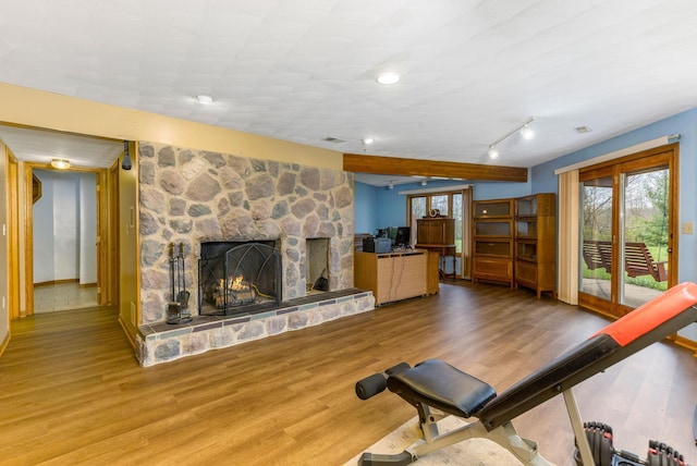 8778 Township Rd 36, Somerset, OH 43783 - exercise area with visible vents, a stone fireplace, and wood finished floors