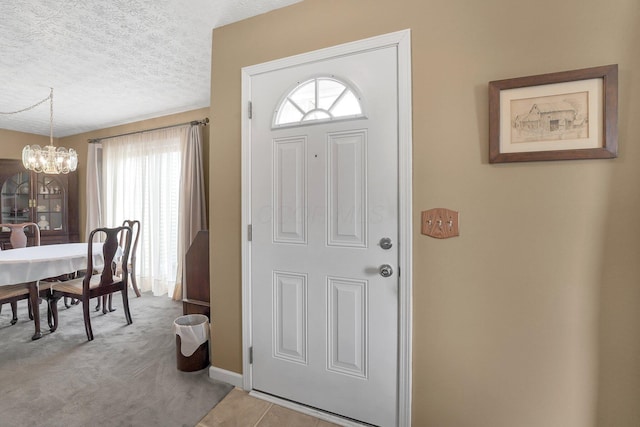 6346 Well Fleet Dr Unit 96, Columbus, OH 43231 - entrance foyer with a chandelier, a textured ceiling, light colored carpet, and baseboards