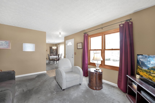 6346 Well Fleet Dr Unit 96, Columbus, OH 43231 - living area with baseboards, carpet flooring, an inviting chandelier, and a textured ceiling