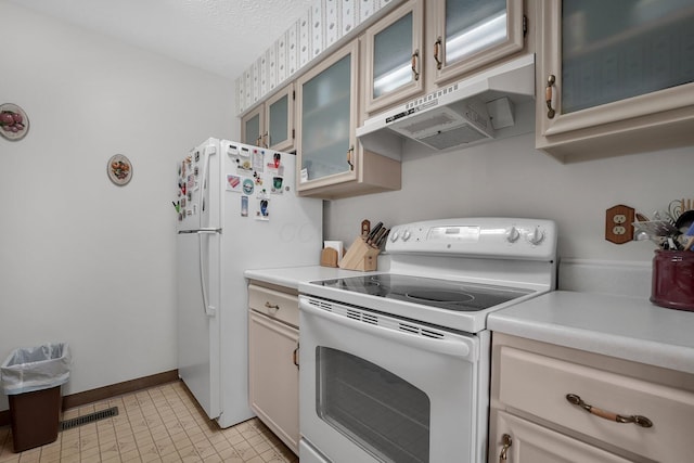 6346 Well Fleet Dr Unit 96, Columbus, OH 43231 - kitchen featuring visible vents, glass insert cabinets, light countertops, white appliances, and under cabinet range hood