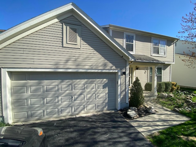 view of front of property with an attached garage and aphalt driveway