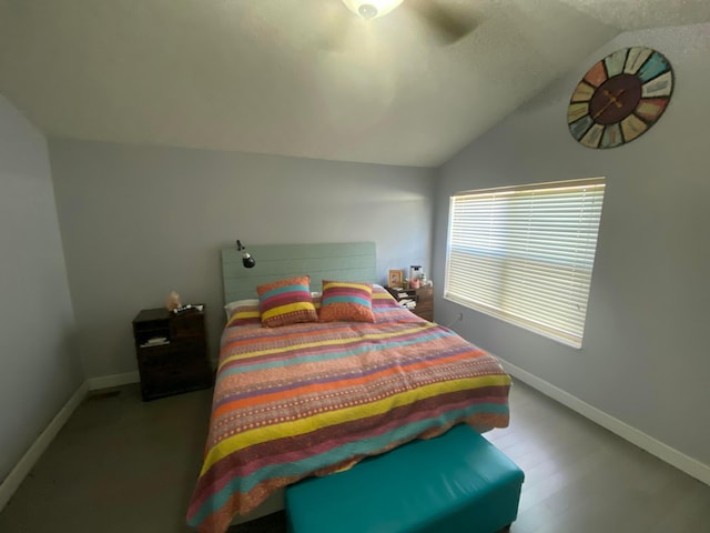 bedroom with baseboards and vaulted ceiling