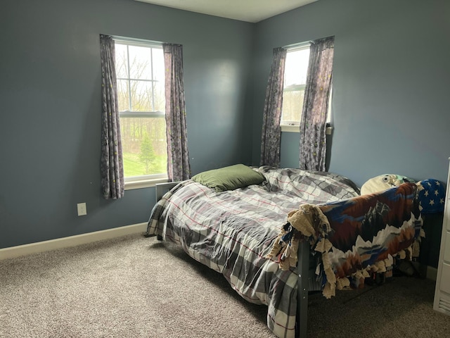 carpeted bedroom featuring baseboards
