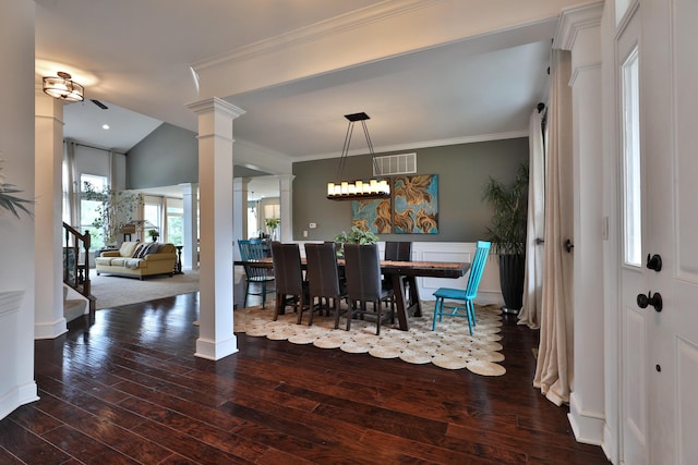 dining space featuring crown molding, visible vents, ornate columns, and wood-type flooring
