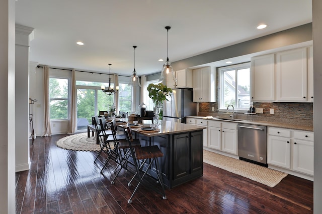 kitchen with tasteful backsplash, appliances with stainless steel finishes, recessed lighting, and dark wood-style flooring