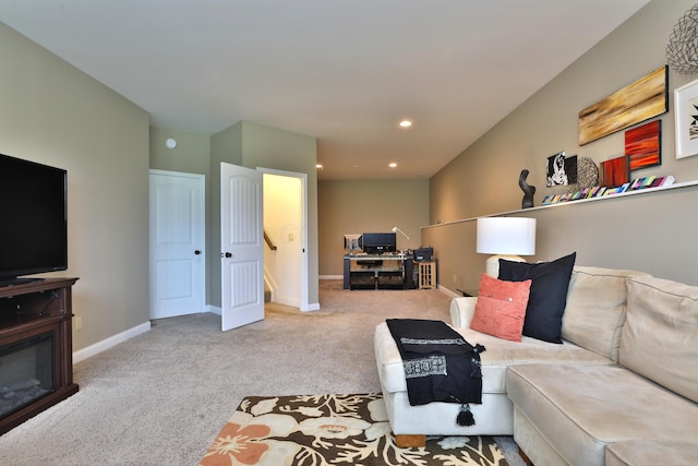 carpeted living area featuring baseboards and recessed lighting