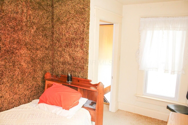 bedroom featuring carpet floors and multiple windows