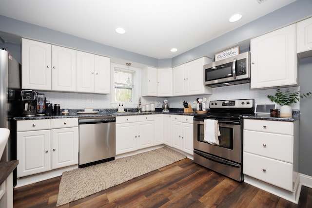 5514 Fairfield Rd, Orient, OH 43146 - kitchen featuring appliances with stainless steel finishes, dark countertops, white cabinetry, decorative backsplash, and recessed lighting