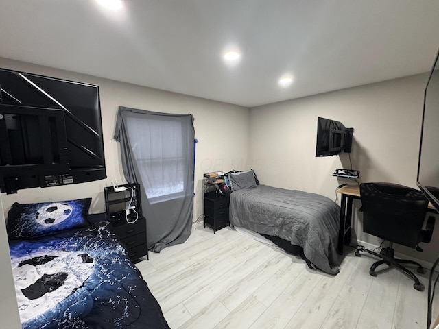 bedroom with recessed lighting and light wood-type flooring