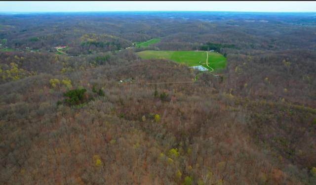 aerial view featuring a wooded view