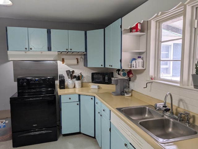 kitchen featuring blue cabinetry, backsplash, black appliances, under cabinet range hood, and a sink