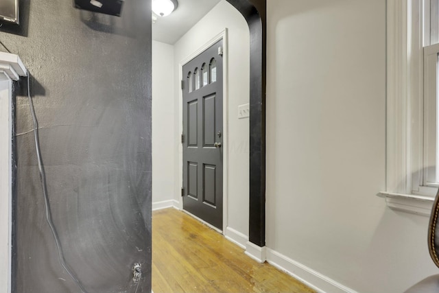 interior space with baseboards and light wood-type flooring
