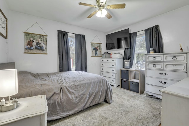 bedroom with light colored carpet and ceiling fan