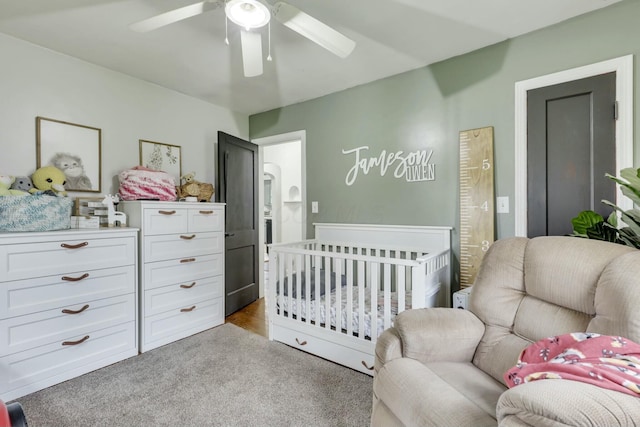 bedroom featuring carpet flooring, ensuite bath, and a ceiling fan