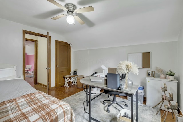 bedroom with ceiling fan, light wood-style flooring, baseboards, and lofted ceiling