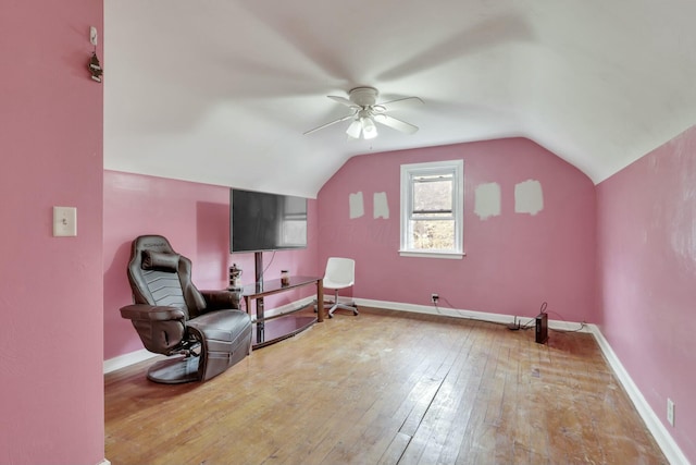 sitting room with baseboards, a ceiling fan, hardwood / wood-style flooring, and lofted ceiling