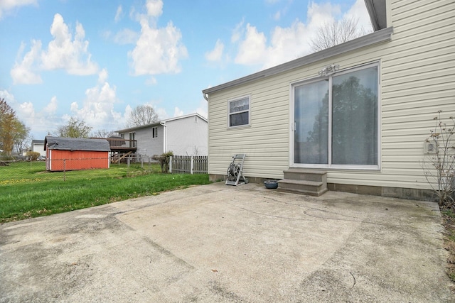 rear view of house with a patio, entry steps, fence, and a lawn