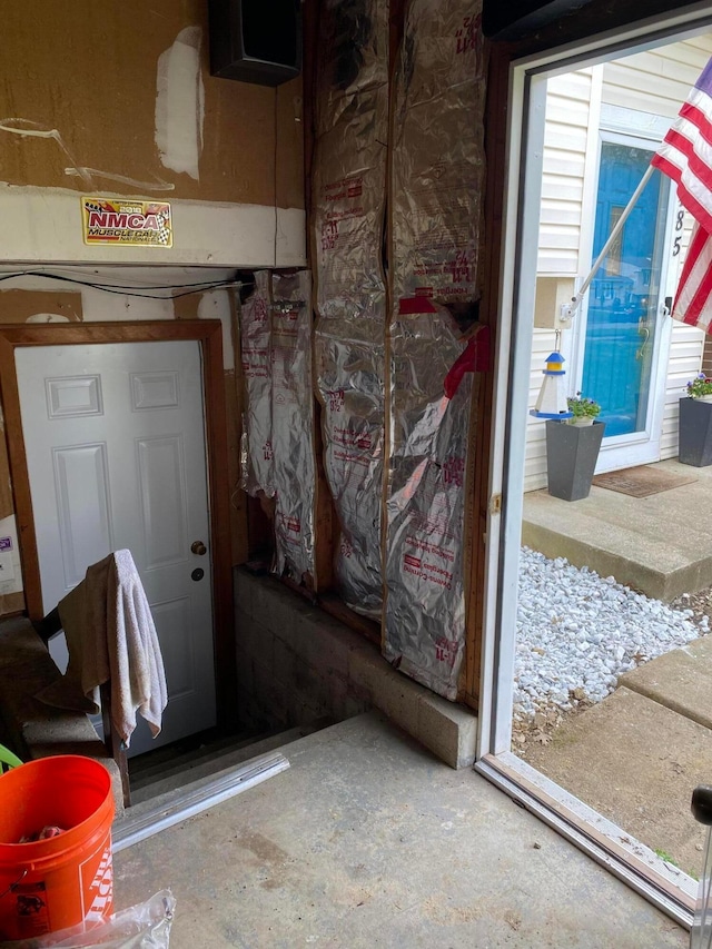 doorway with unfinished concrete flooring
