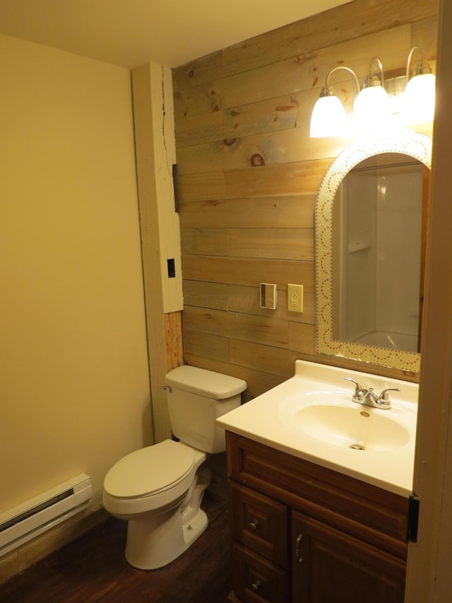 11 Plumb St, Lockbourne, OH 43137 - bathroom with vanity, toilet, wood finished floors, wood walls, and a baseboard radiator