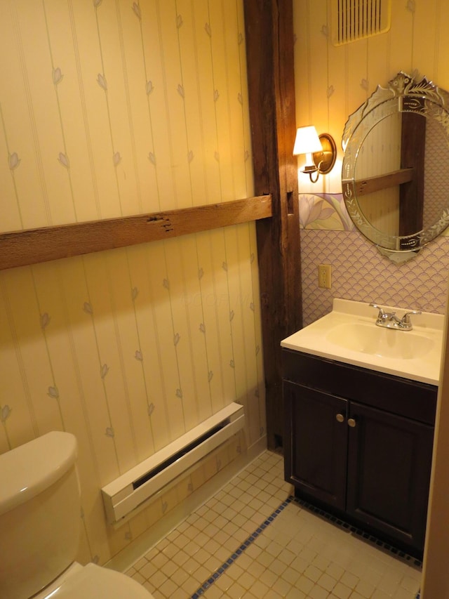 11 Plumb St, Lockbourne, OH 43137 - bathroom with vanity, wallpapered walls, tile patterned floors, toilet, and a baseboard radiator