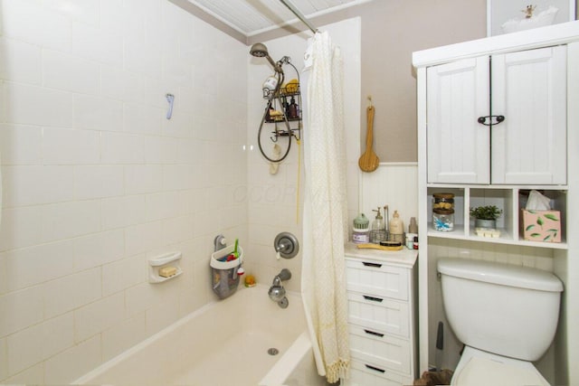 full bath featuring shower / bath combination with curtain, a wainscoted wall, and toilet