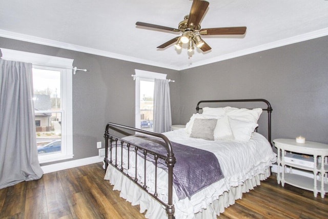 bedroom with ceiling fan, baseboards, crown molding, and wood finished floors
