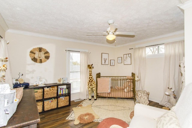 interior space with wood finished floors, ceiling fan, ornamental molding, and plenty of natural light
