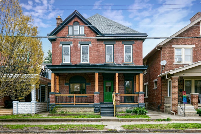 344 E Whittier St, Columbus, OH 43206 - view of front of house featuring cooling unit, roof with shingles, covered porch, and brick siding