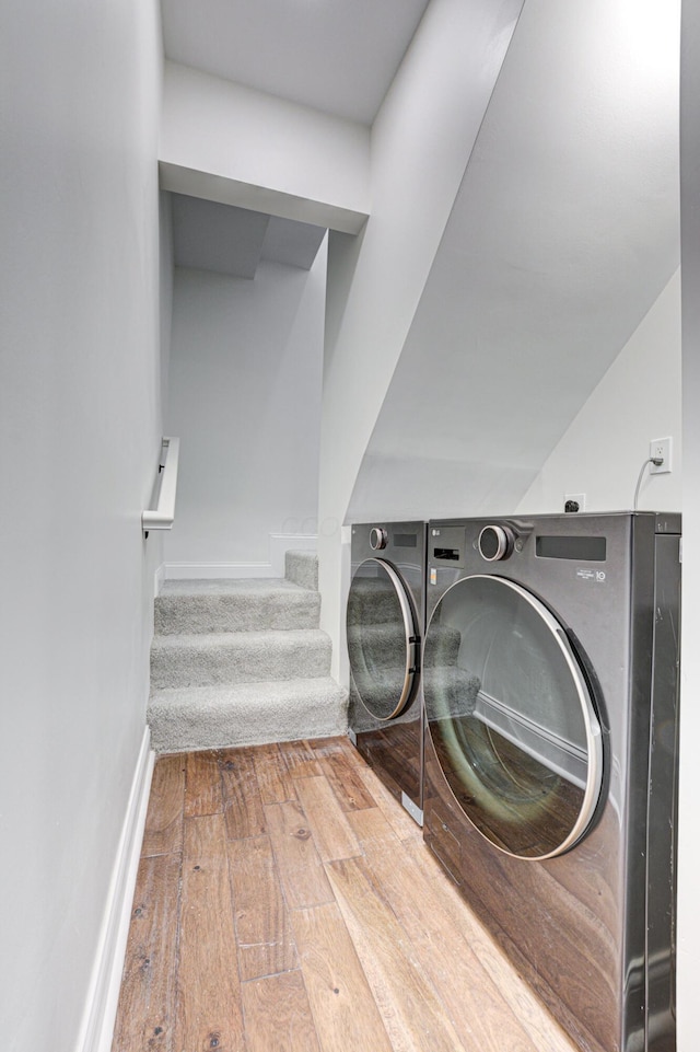 344 E Whittier St, Columbus, OH 43206 - laundry area featuring hardwood / wood-style floors, washing machine and clothes dryer, laundry area, and baseboards
