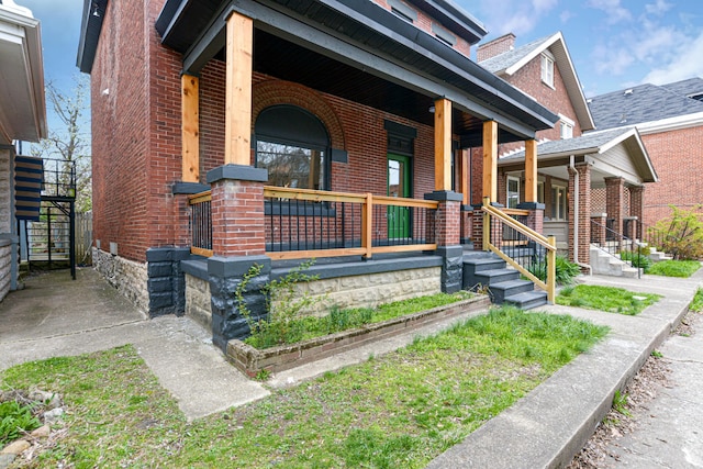 344 E Whittier St, Columbus, OH 43206 - view of front facade with covered porch and brick siding