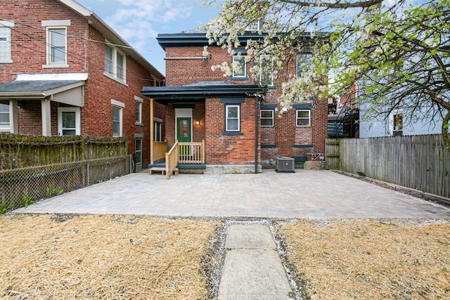 344 E Whittier St, Columbus, OH 43206 - rear view of house with brick siding, a fenced backyard, and a patio area