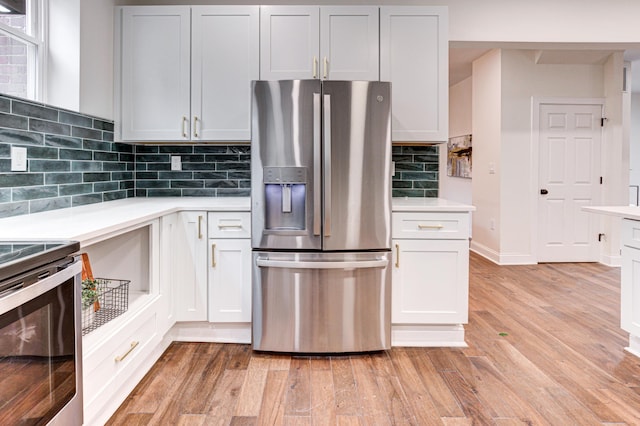 344 E Whittier St, Columbus, OH 43206 - kitchen with light wood finished floors, tasteful backsplash, stainless steel appliances, and light countertops