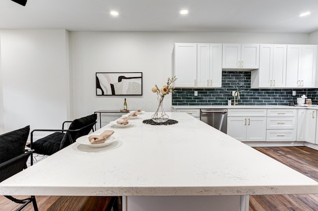 344 E Whittier St, Columbus, OH 43206 - kitchen with dark wood-style flooring, a kitchen bar, a center island, white cabinetry, and stainless steel dishwasher