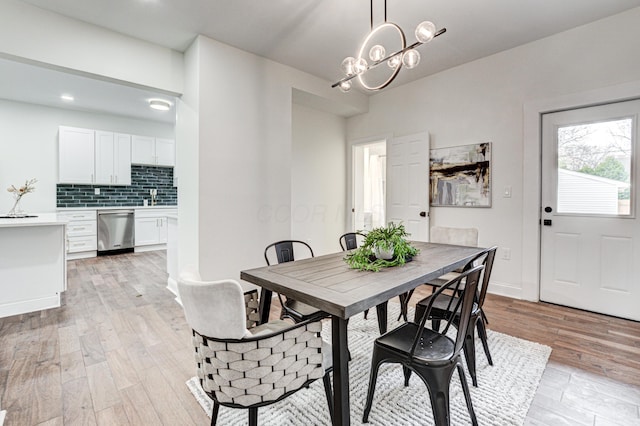344 E Whittier St, Columbus, OH 43206 - dining space with light wood finished floors, recessed lighting, and a chandelier