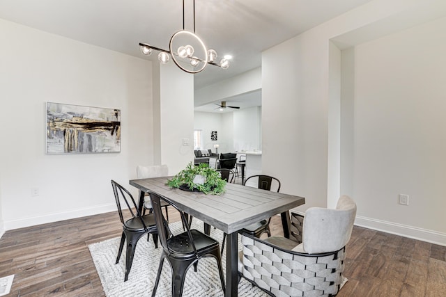 344 E Whittier St, Columbus, OH 43206 - dining room featuring ceiling fan with notable chandelier, wood finished floors, and baseboards