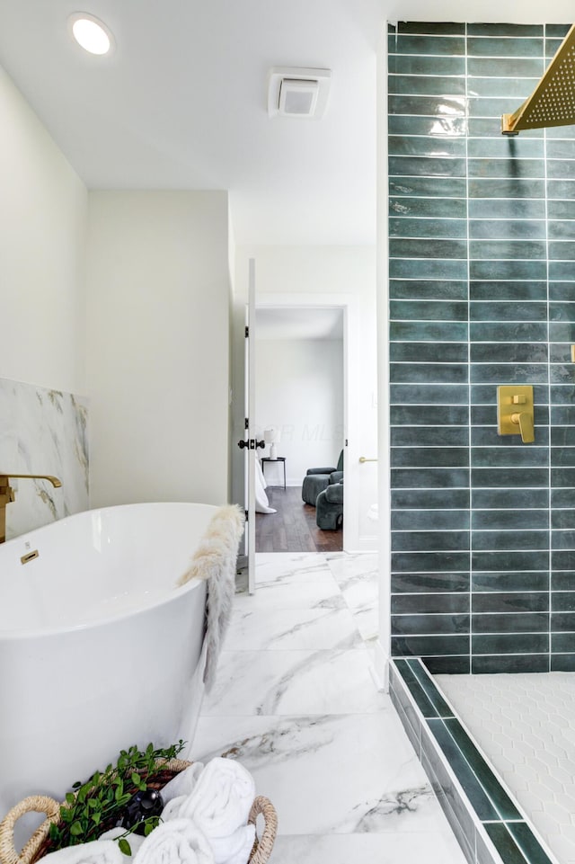 344 E Whittier St, Columbus, OH 43206 - bathroom featuring a tile shower, marble finish floor, a freestanding bath, and recessed lighting