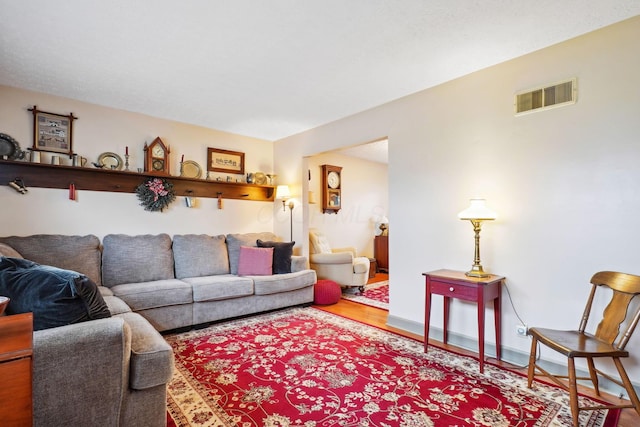 living room featuring wood finished floors and visible vents