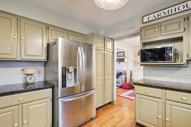 kitchen featuring stainless steel appliances, tile countertops, and cream cabinetry