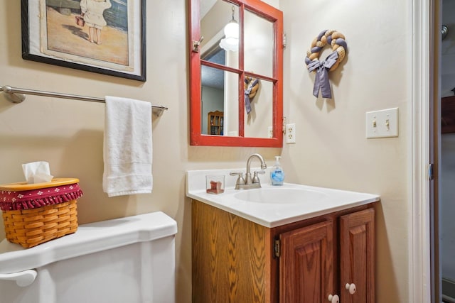 bathroom featuring toilet and vanity
